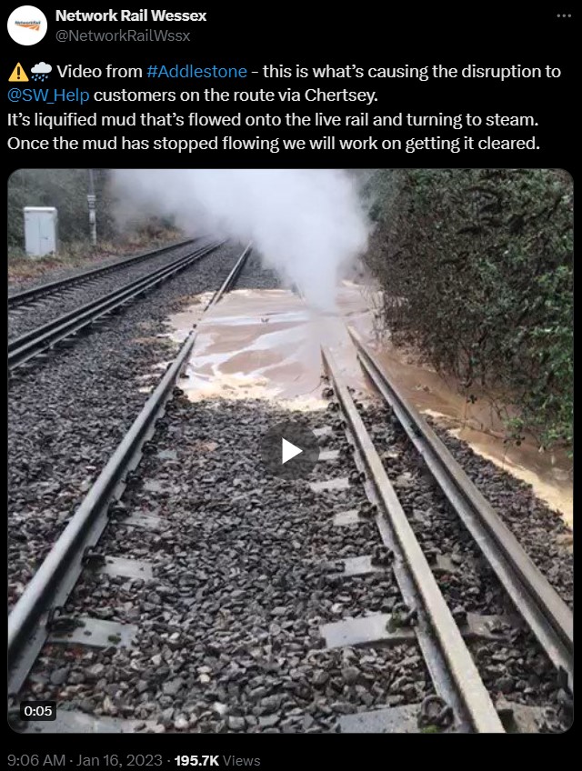 Liquid mud flowing onto a railway. The railway is electrified with a 3rd rail. Steam is coming from the mud/rail as the mud is boiling 